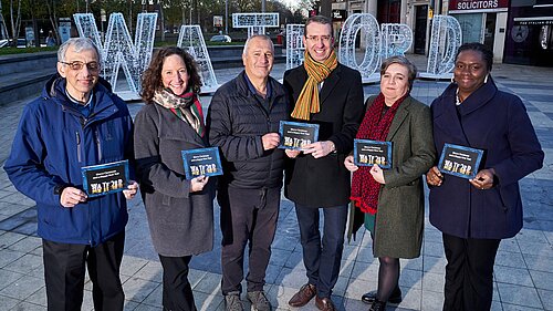 Peter, the competition winner and workers from recipient charities